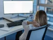 Lady with sore neck from laptop use in office in Newcastle